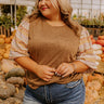 A warm and stylish knit top, perfect for layering in cooler seasons.
