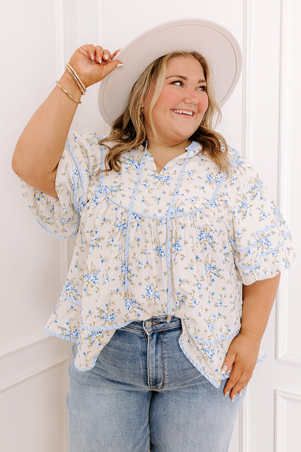 A romantic floral top with soft hues and delicate detailing.